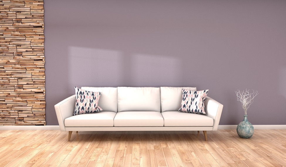 weißes Sofa vor grauer Wand